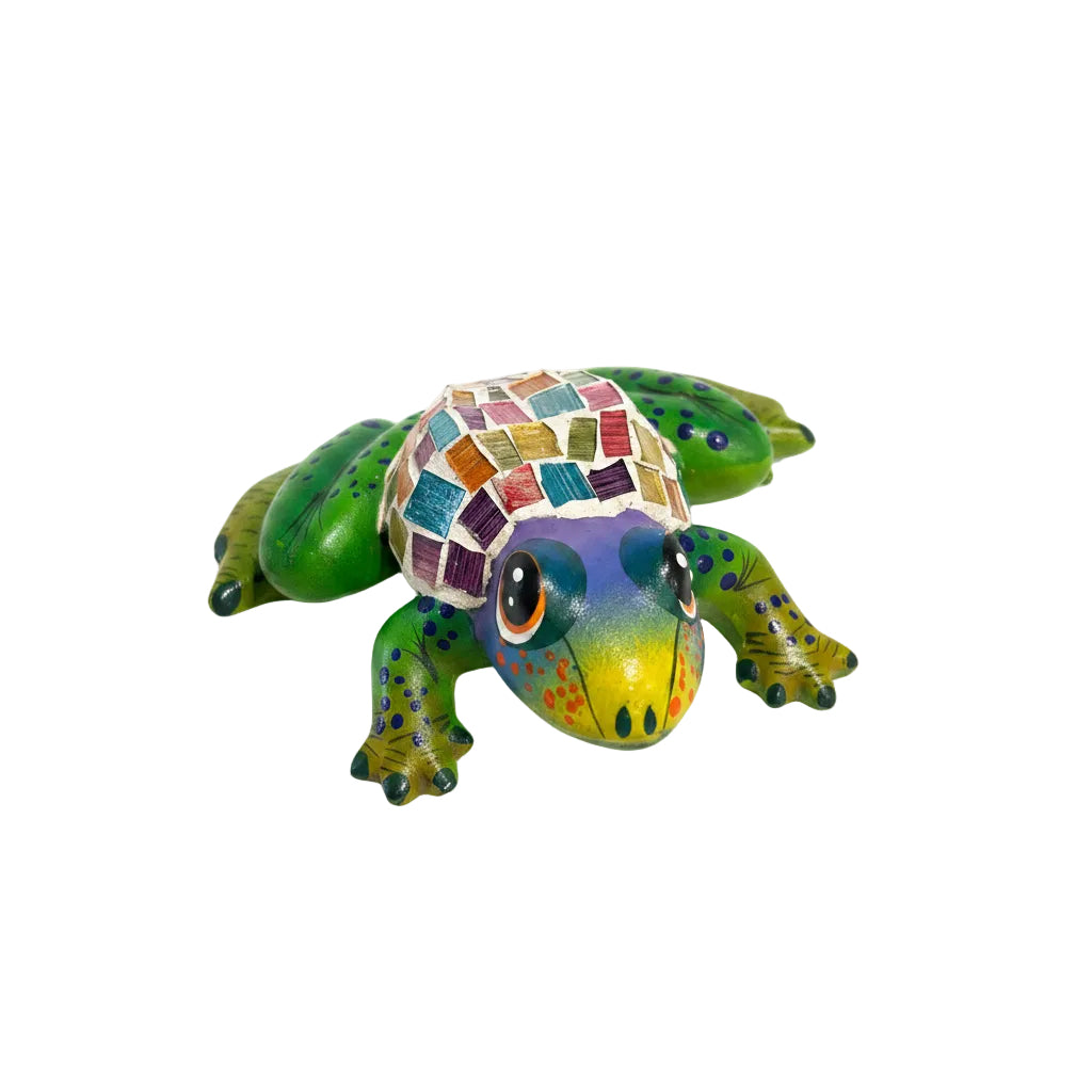 Colorful frog figurine on a white surface