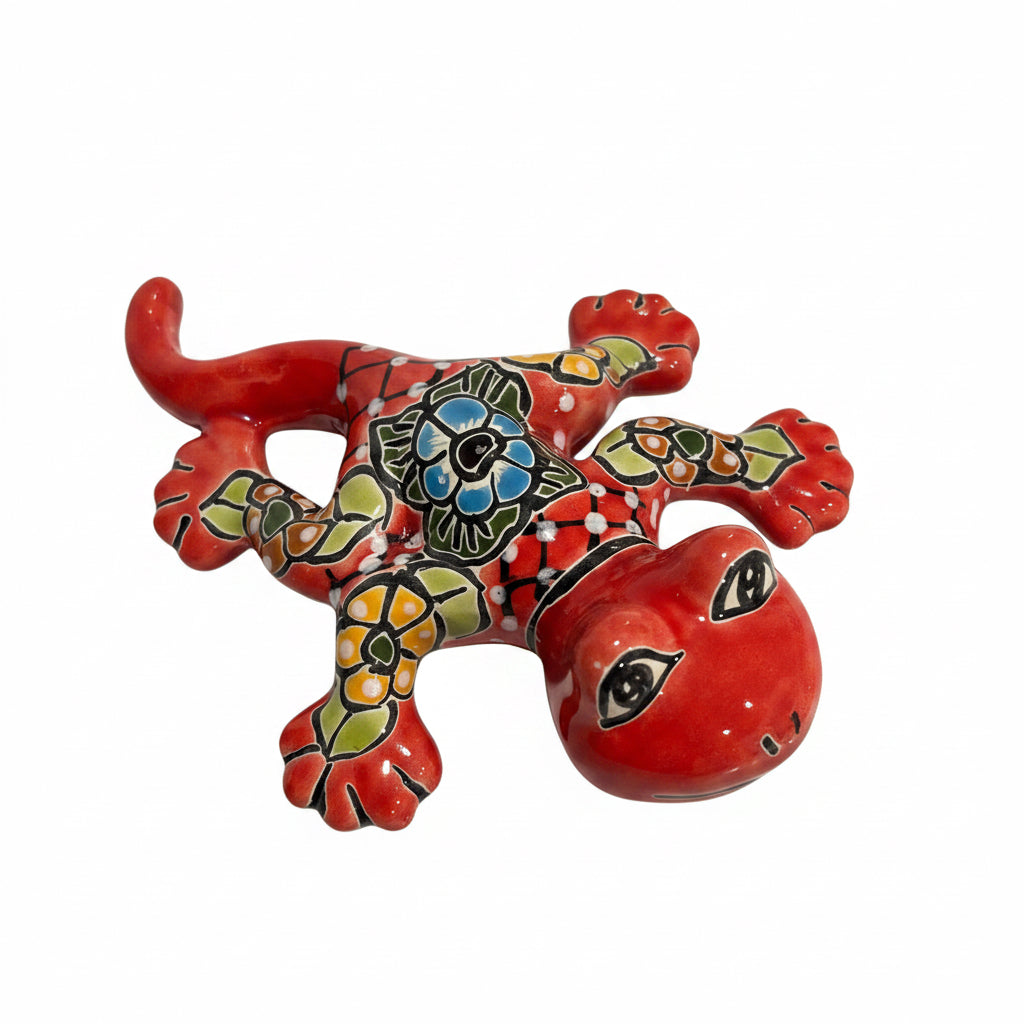 Colorful ceramic Talavera salamander figurines on a light gray surface