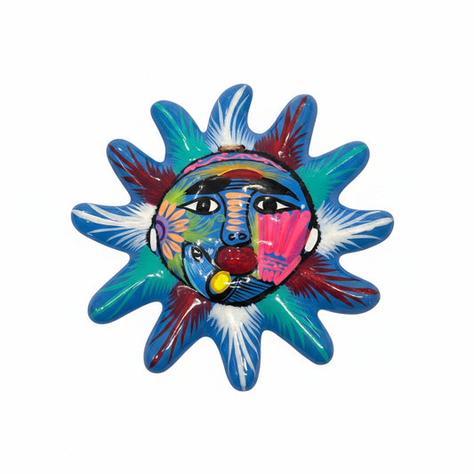 Colorful sun-shaped decorative item with a face design on a white background