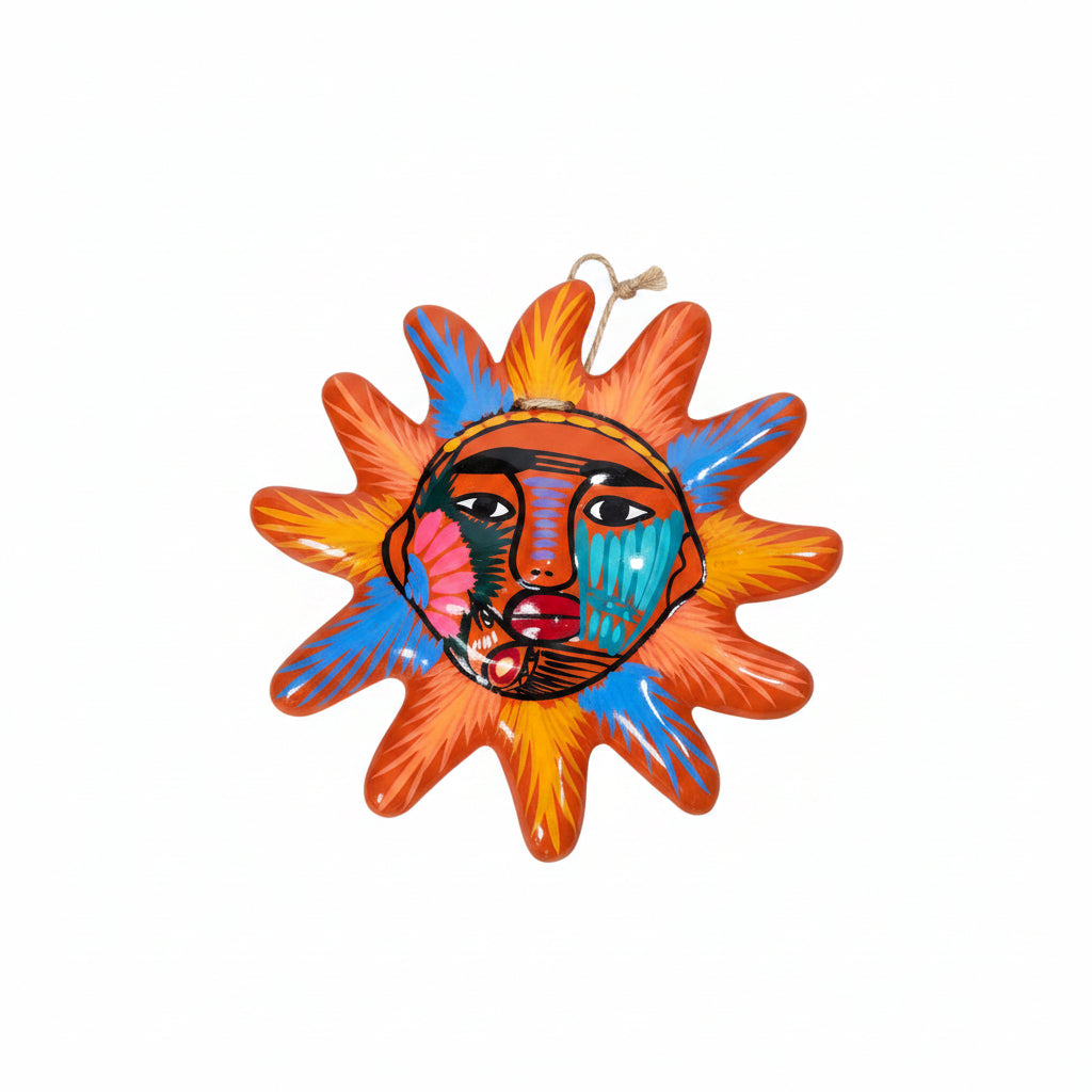 Colorful sun-shaped decorative item with a face design on a white background
