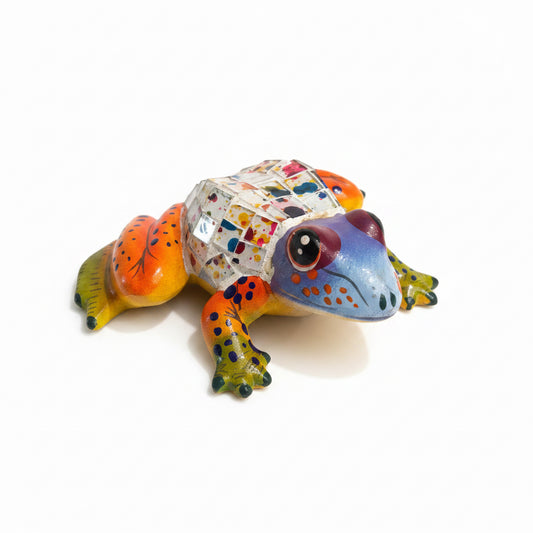 Colorful frog figurine on a light-colored surface