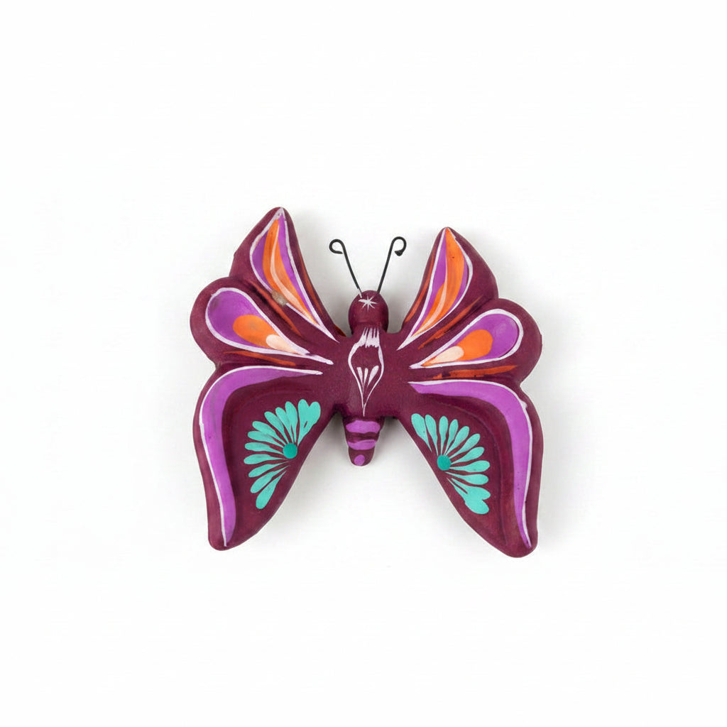 Decorative butterfly wall art with purple and orange colors on a light background