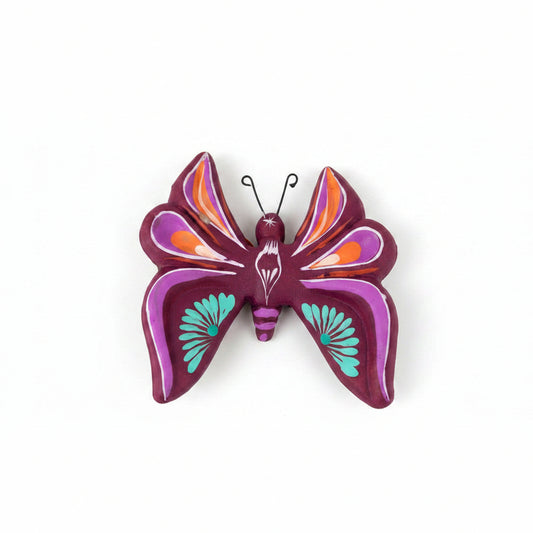 Decorative butterfly wall art with purple and orange colors on a light background